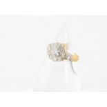 An Edwardian diamond set cluster ring, the central old cut in platinum setting approximately 0.45ct,