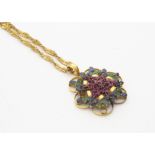 A multi gem set pendant, in yellow metal on a fine curb link twist chain marked 916, the flower