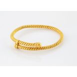 A continental yellow metal rope twist torque bangle, of crossover design, unmarked, internal