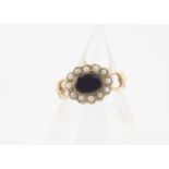 A 9ct gold enamel and seed pearl dress ring, in the style of an 18th Century mourning ring with oval