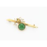 A Chinese 18ct gold and jade spider bar brooch, the central gold spider with jade cabochon