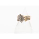 A diamond cluster ring, the central oval cluster with claw set brilliant cuts on a crossover setting