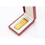 A Must De Cartier gilt cigarette lighter, with red enamel band to upper, in box