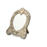 An Edwardian silver fronted mirror, possibly by William Comyns, with heart shaped mirror panel and