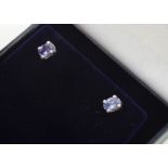 A pair of oval mixed cut tanzanite ear studs, in four claw settings with post backs, boxed