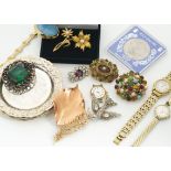 A collection of costume jewellery, including a paste set bird brooch, a simulated Edwardian target