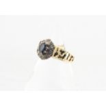 An 18ct gold sapphire and diamond dress ring, the oval mixed cut sapphire in claw setting raised