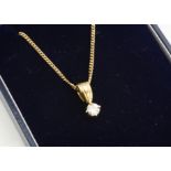 A diamond solitaire drop pendant, the four claw brilliant cut in 18ct yellow gold on a 9ct yellow