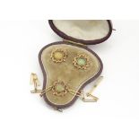 A set of three yellow metal chain linked paste set dress studs, in fitted leather shaped case, 6.1g