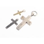 A white metal cross pendant, 7cm x 3.3cm together with an ebony and white metal crucifix pendant 4.