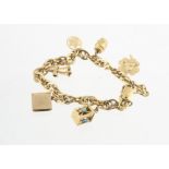 An 18ct gold multi oval linked charm bracelet, with various gold charms including a 14ct gold