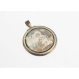 A Georgian gilt metal and verre eglomise circular watercolour pendant, with glazed box back