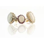 Two 18ct gold white opal dress rings, both claw set, one with white sapphire bezel, the other set