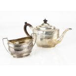 A Georgian style white metal teapot and similar sugar basin, the oval teapot with wooden handle