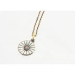 A George Jensen silver gilt and enamel daisy pendant and chain, the white enamel pendant on an