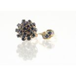 A continental sapphire dress ring, the high set cluster on a raised basket setting and yellow