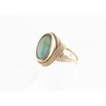 A continental turquoise and yellow metal dress ring, the oval blue turquoise cabochon in a rope