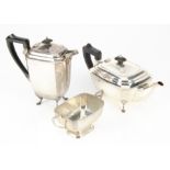 An Art Deco style three piece silver tea set by KB, comprising hot water jug, teapot and sugar