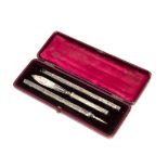 A late Victorian silver three pen set, in fitted box, with pencil, quill holder and blade (4)