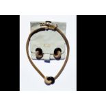 A Christian Dior necklace and earring set, black enamel and paste stones, within a pave setting,