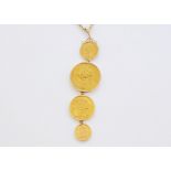 An impressive four Victorian gold coin pendant necklace, each of the coins dated 1887, VF, in a