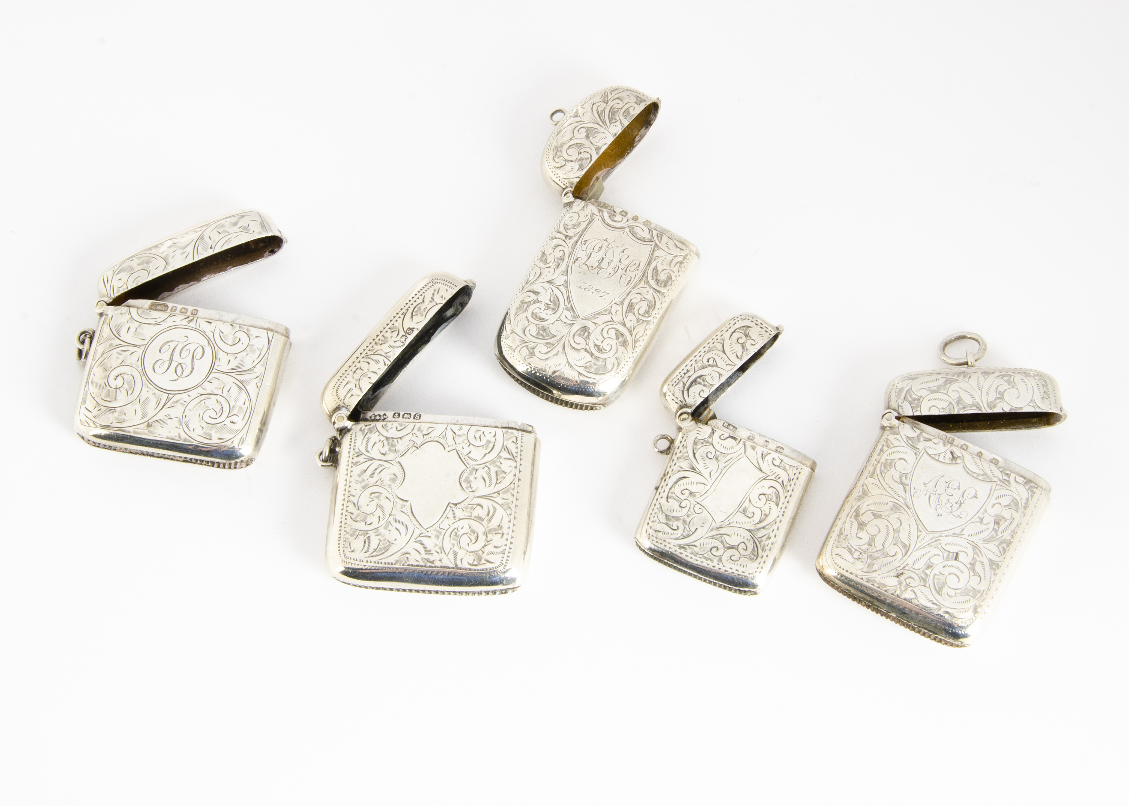 Five Victorian and later silver vesta cases, two square, two rectangular and one oblong, all with