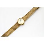 A c1960s Omega gold lady~s wristwatch, circular case on integrated mesh strap, 25g