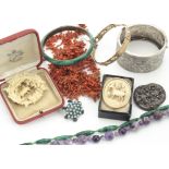 A collection of coral unstrung beads, an amethyst necklace, a malachite example, malachite bangle,
