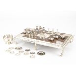 An interesting miniature white metal and oak Queen Anne style dining table and tableware, the