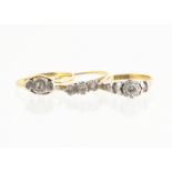 An 18ct gold platinum set diamond solitaire, the raised setting with stylised leaf decoration and