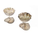 A pair of early 20th Century Middle Eastern white metal dishes, with leaf base and stem support