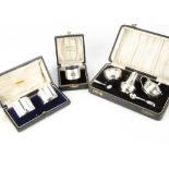A 1950s cased silver three piece cruet set, together with a pair of cased napkin rings and a