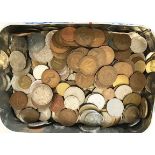 A collection of coins and other items, including stamps, postcards, bank notes, and matchboxes