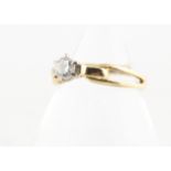 An 18ct gold diamond solitaire, the brilliant cut diamond in six claw setting on a scroll and