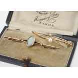 An Edwardian yellow metal and precious opal bar brooch, marked 9ct in a fitted leather box from