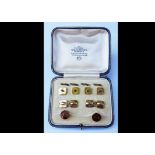 An 18ct and 9ct gold mother of pearl and seed pearl dress stud set, comprising four studs with split