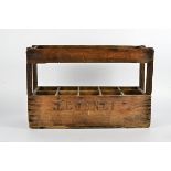 A wooden wine bottle holder rack, stamped 'E C O S N C F', length 57cm, height 37cm