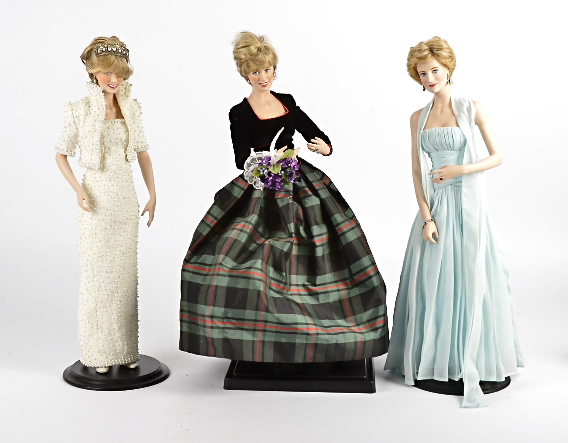 Three Princess Diana china dolls, dressed in memorable outfits, probably Franklin Mint, height