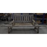 A contemporary slatted garden bench, with extending barrow like handles, the four legs with arch