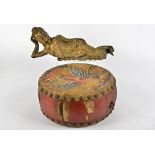 A East Asian reclining figure, heightened in gilt, length 42cm, together with an Oriental drum,