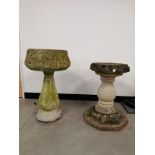 Two bird baths, one with rounded scrolling foliate design top, upon a multi faceted plinth, height