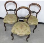 Three 19th Century walnut balloon back dining chairs, with carved top and centre rails,