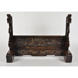 A Chinese hardwood framed stand, with carved decoration of flowers and temple dogs, 62.5cm x 45cm
