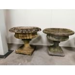 A companion pair of shallow urns, both raised on square plinths, 50cm x 58cm, and 55cm x 65cm (2)