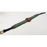 A Tibetan belt, embellished with red glass beads and large turqoise style stones, length 106cm