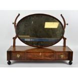 A 20th Century dressing table mirror, the oval mirror above three drawers with brass handles,