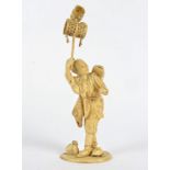 A Meiji period Japanese ivory okimono of a theatrical entertainer, with mask by his feet and