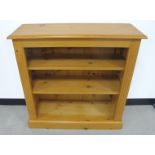 A contemporary pine open bookcase, with moulded top, two adjustable shelves and plinth base, 91cm