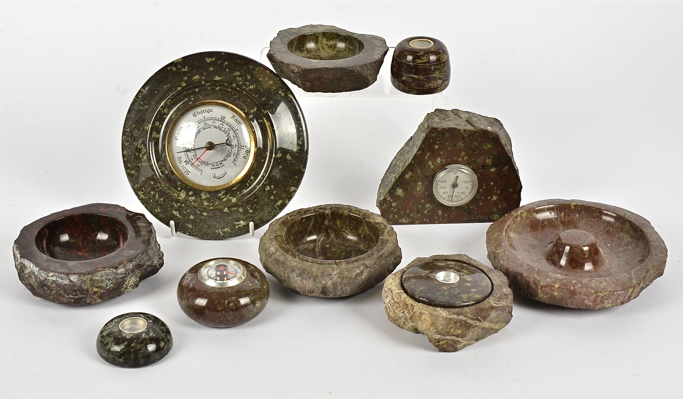 A group of serpentine stone ware collectables, including barometers and compasses, diameter f