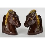 A pair of pottery bookends, modelled as horses heads (2)